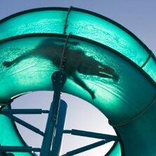 Silhouette of person riding a fibreglass hydroslide
