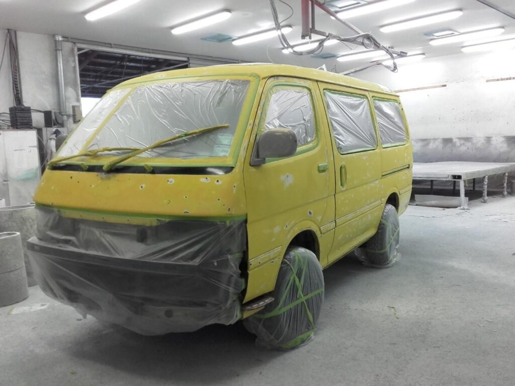 Van in our fibreglass work bay, primed and ready for Speedliner application