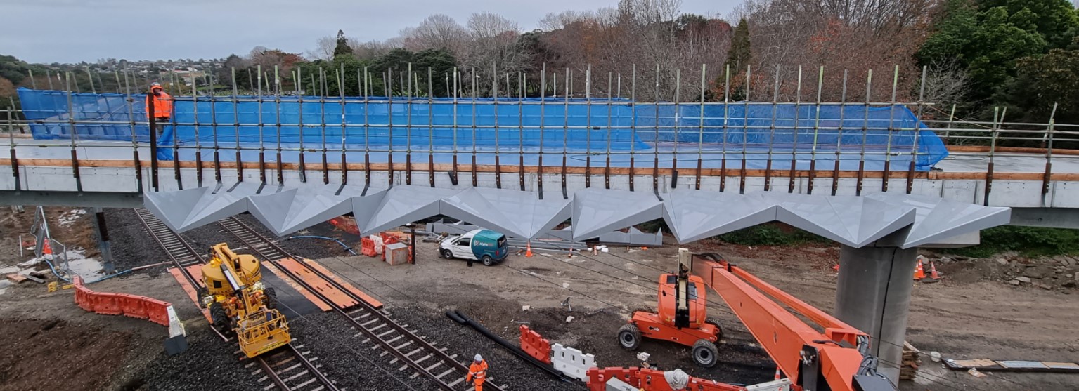 Over-bridge safety screen for electric railways
