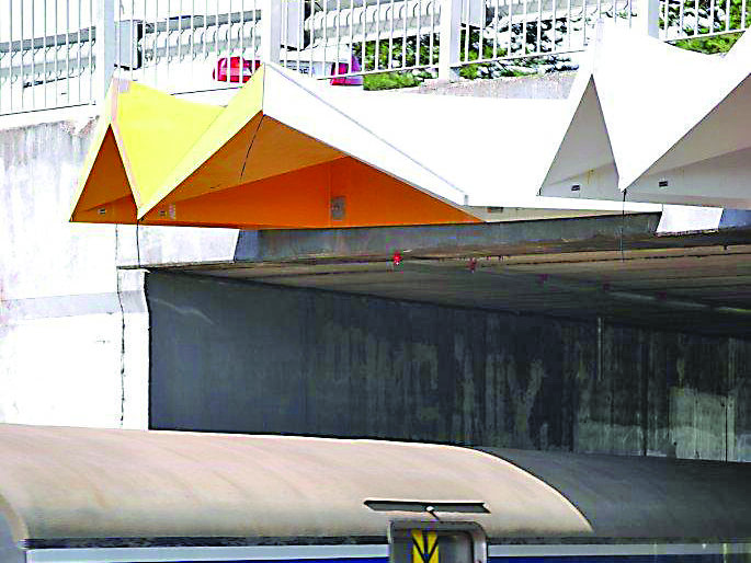 Over-bridge safety screen for electric railways